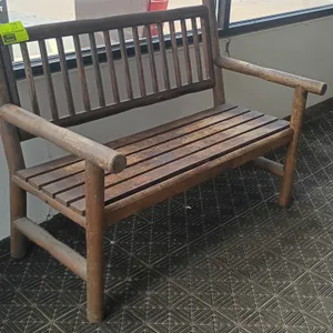 Wood bench with armrests. Features slatted seat, spindle backrest, and rounded timber frame. Dimensions: 48"W x 28"D x 36"H.