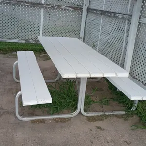 Poly picnic table with attached benches. Features white slatted top and bench seating. Mounted on a metal tubular frame. 84"L x 62"W x 31"H.