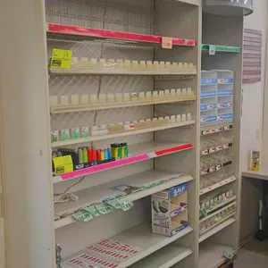 Marlboro retail cigarette display racks. Features illuminated Marlboro header signage, adjustable metal shelving, product pushers, and price channels.