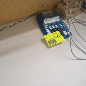 Assorted office equipment and supplies. Includes printing calculator, multi-line desk phone, and desk accessories. Desk and background items not inclu
