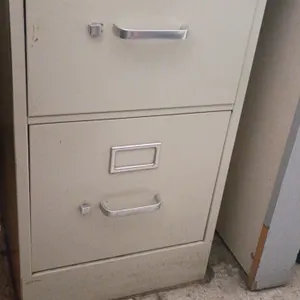 HON 2-drawer vertical metal filing cabinet. Features aluminum pull handles and built-in label holders. 15"W x 25"D x 29"H.