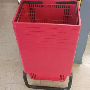 Poly shopping baskets with stand. Features red plastic construction with dual black folding handles and ventilated sides. Includes tubular metal floor