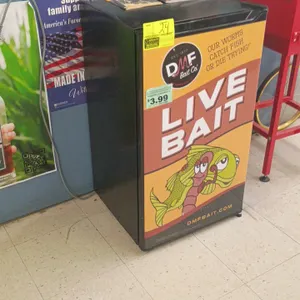 Compact single-door mini refrigerator. Features DMF Bait Co. Live Bait graphic door wrap, interior shelving, and in-door storage bins. 18" x 18" x 33"