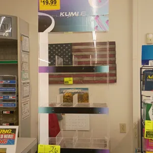Acrylic countertop display rack. Features 4 tiers with clear product dividers and Kumi branded graphics. 13"W x 8"D x 35"H.