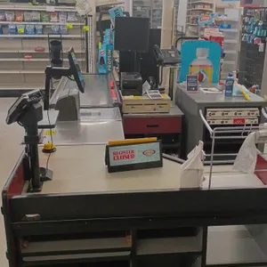 Load King single belt checkout lane with integrated NCR POS system. Features motorized conveyor belt, built-in scanner scale, NCR touchscreen terminal