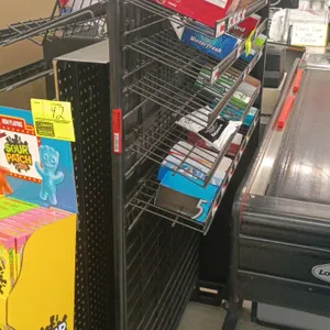 Check lane candy display rack. Features multi-tier angled wire shelving and pegboard backing. Black metal construction. 40"L x 22"W x 58"H. Contents n