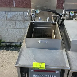 Henny Penny 500 electric pressure fryer. Features Computron 8000 digital controls, stainless steel construction, wire fry basket, and built-in filtrat