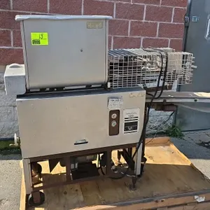 Hollymatic 580 patty machine. Features stainless steel hopper, product discharge conveyor, and wire safety guard. Powered by a Baldor motor. Mounted o