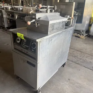 Henny Penny 500 electric pressure fryer. Features stainless steel construction, locking lid assembly, and front dial controls. S/N: LB004IG. Electrica