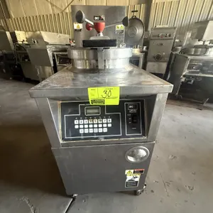 2010 BKI LGF-FC commercial pressure fryer. Features digital touchpad controls, round fry pot with internal basket, and built-in filtration drawer. Gas
