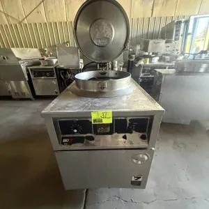 2002 BKI FKM-F commercial electric pressure fryer. Features stainless steel construction, hinged pressure locking lid, round fry pot with wire basket,