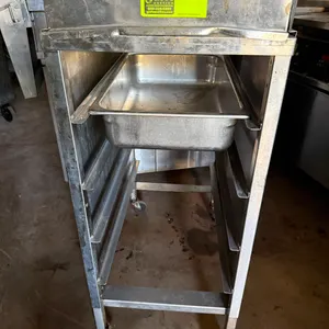 Stainless steel mobile breading station. Features upper breading well with splash collar, multi-tier under-counter pan slides, and (1) stainless steel