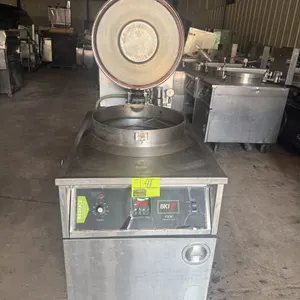 2005 BKI FKM-F electric pressure fryer. Features stainless steel construction, round fry pot with wire basket, locking lid assembly, pressure gauge, a