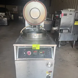 2010 BKI FKM-F commercial pressure fryer. Features stainless steel construction, locking pressure lid, round fry pot with wire basket, digital control