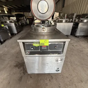 BKI FKM commercial pressure fryer. Features stainless steel construction, round fry pot with wire basket, locking lid mechanism, digital control panel