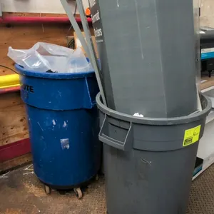 Rubbermaid Brute 44-gallon poly portable waste bins. Includes (1) blue and (1) gray container. Features integrated side handles and molded poly constr