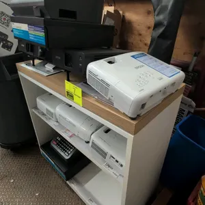 Laminate display cabinet. Features white laminate construction with wood-look top trim and two open shelves. 34"W x 31"H. Contents not included.