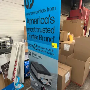 Free-standing retail sign stand. Features HP Smart Tank Series Printers graphic banner. 90"H. Mounted on metal support feet.
