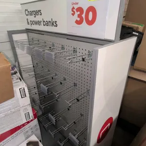 Double-sided metal merchandise display rack. Features perforated metal pegboard panels on both sides, metal peg hooks with tag holders, side panels, a