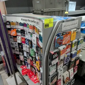 Laminate portable double-sided merchandise display rack. Features curved side panels, perforated display panels with hanging hooks, and header signage