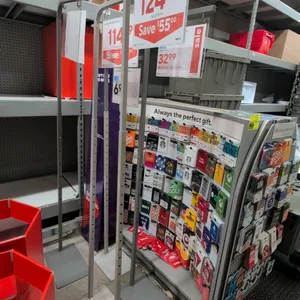 Metal adjustable floor sign stands. Features telescoping height-adjustable uprights with push-button stops, flat metal base plates, and top horizontal