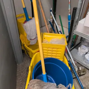 Polyethylene commercial mop buckets with wringers. Includes mop handles and mop heads. Yellow molded plastic construction with side-press wringers. Mo