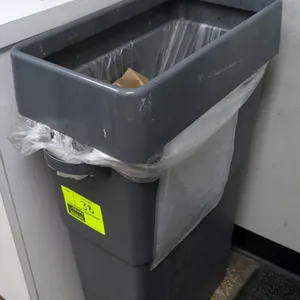 Poly waste bin. Features gray molded plastic construction with top rim collar. Contents not included.