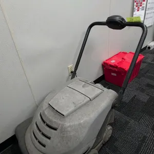 Walk-behind battery-powered floor sweeper. Features digital control interface with battery level indicator, selectable sweeping modes, onboard battery
