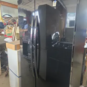 Kenmoore cold spot side by side refrigerator with Ice dispensing door.