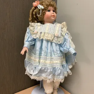 Dynasty Doll Collection Cardinal Inc. Bisque Porcelain Doll With Blue Dress, Lace, and Flowers Stand