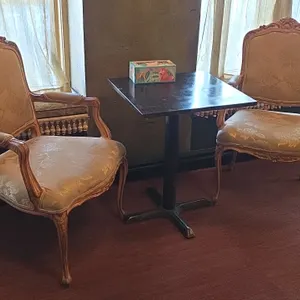 2 upholstered wood frame chairs with 24" x 30"h wood metal base pedestal table