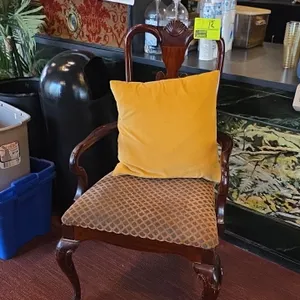 Upholstered wood frame chair with pillow