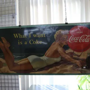 Cardboard Coca-Cola advertising sign marked Lithograph in Canada, 27 1/2" H X 57" W