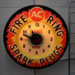Vintage molded plastic electric AC Fire Ring Spark Plugs illuminating wall clock, working at time of