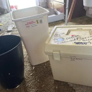 Two trash cans and a filing box