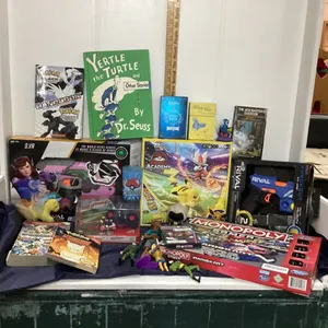BOX W/ VARIOUS BOARD GAMES, NERF GUNS, POKÉMON BOOKS/CUP/GAME, ACTION FIGURES ETC