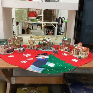CHRISTMAS VILLAGE  - (6) BUILDINGS, A FEW ACCESSORIES - IN A GOOD LIDDED TOTE AND A TREE SKIRT