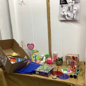 BOX W/ MISC NEW STOCKING STUFFER ITEMS - BATTERY OPERATED TOOTHBRUSH, JEWELRY HOLDER,  TRAVEL MONOPOLY,  KEY CHAINS