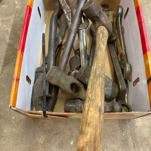 Assortment of hammer heads and wrenches