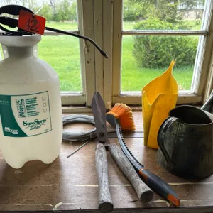 Weed sprayer jugs and pruning shears clothes line cable