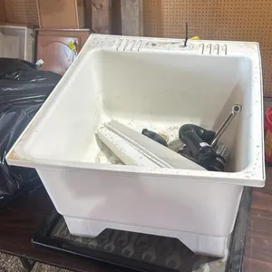 Laundry sink with plumbing fixtures