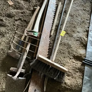 Assortment of yard tools, ax, sledge, hammer, spade