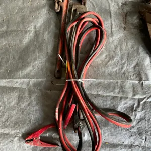 Two pipe wrenches and booster cables