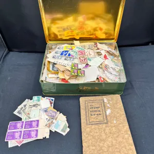 Tin of Assorted Stamps from Around the World & Stamp Stock Book