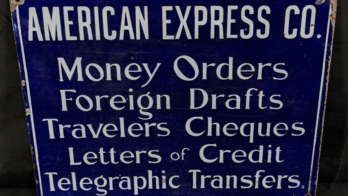 PORCELAIN SIGN AMERICAN EXPRESS CO MONEY ORDERS FOREIGN DRAFTS TRAVELERS CHEQUES LETTERS OF CREDIT TELEGRAPHIC TRANSFERS (2 SIDED)
