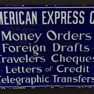 PORCELAIN SIGN AMERICAN EXPRESS CO MONEY ORDERS FOREIGN DRAFTS TRAVELERS CHEQUES LETTERS OF CREDIT TELEGRAPHIC TRANSFERS (2 SIDED)