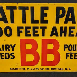 EMBOSSED TIN SIGN CATTLE PASS 500 FEET AHEAD BB DAIRY & POULTRY FEEDS MARITIME MILLING CO BUFFALO NEW YORK