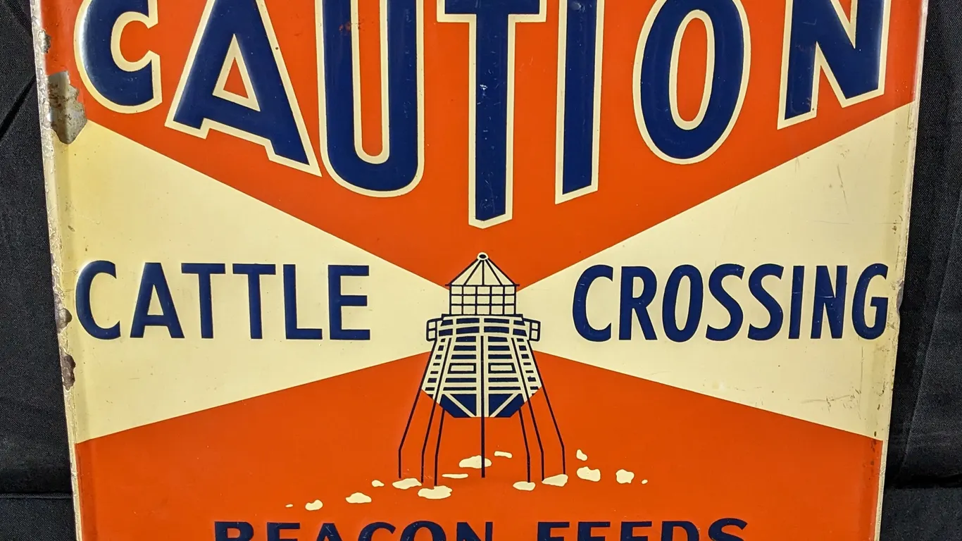 EMBOSED TIN SIGN CAUTION CATTLE CROSSING BACON FEEDS