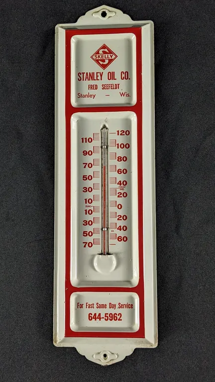 TIN THERMOMETER SIGN SKELLY OIL CO STANLEY WISCONSIN