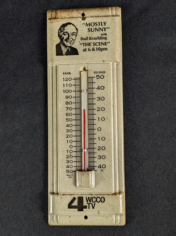 TIN THERMOMETER SIGN"MOSTLY SUNNY" WITH BILL KRAEHLING "THE SCENE" AT 6 & 10PM 4 WCCO TV (TWIN CITES